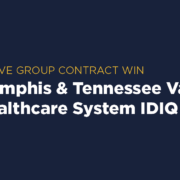 Contract Award: VISN 9 IDIQ Graphic with yellow heading 'Above Group Contract Win' and text 'Memphis & Tennessee Valley Healthcare System IDIQ' on a navy blue background