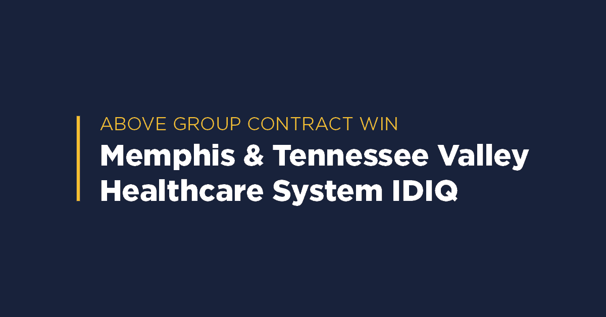 Graphic with yellow heading 'Above Group Contract Win' and text 'Memphis & Tennessee Valley Healthcare System IDIQ' on a navy blue background