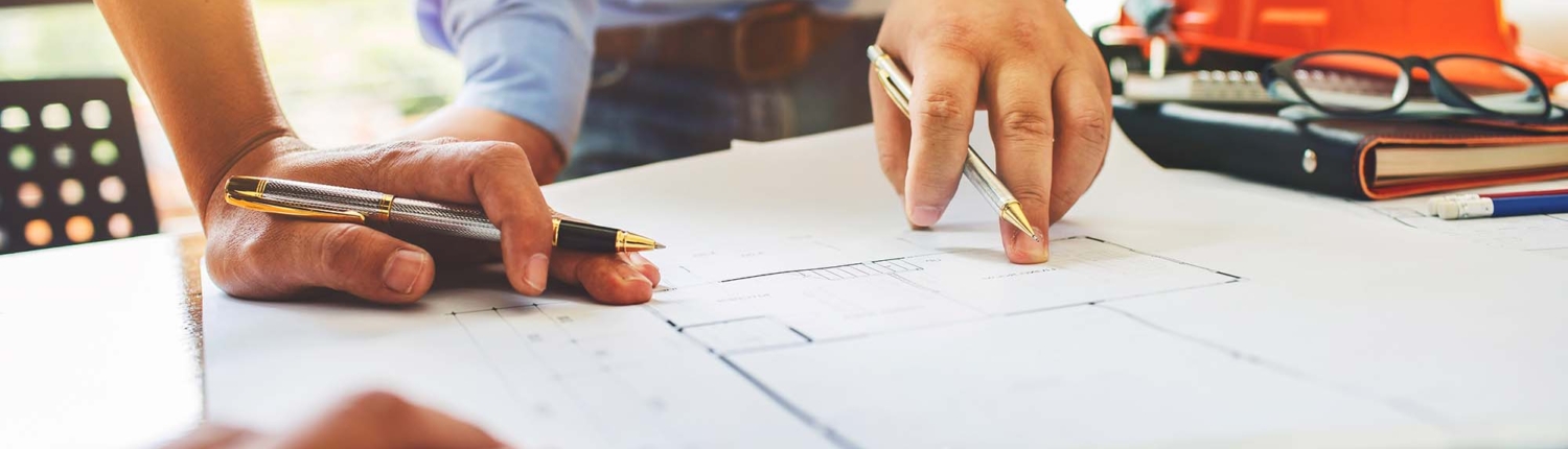 Construction Worker And Arhcitect Looking At Blueprints
