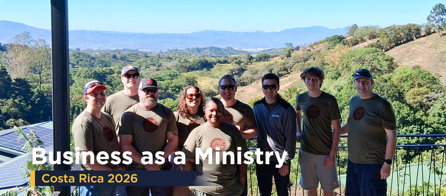 Above Group team members standing together during their annual Business as Ministry mission trip in Costa Rica, with scenic mountain views in the background.