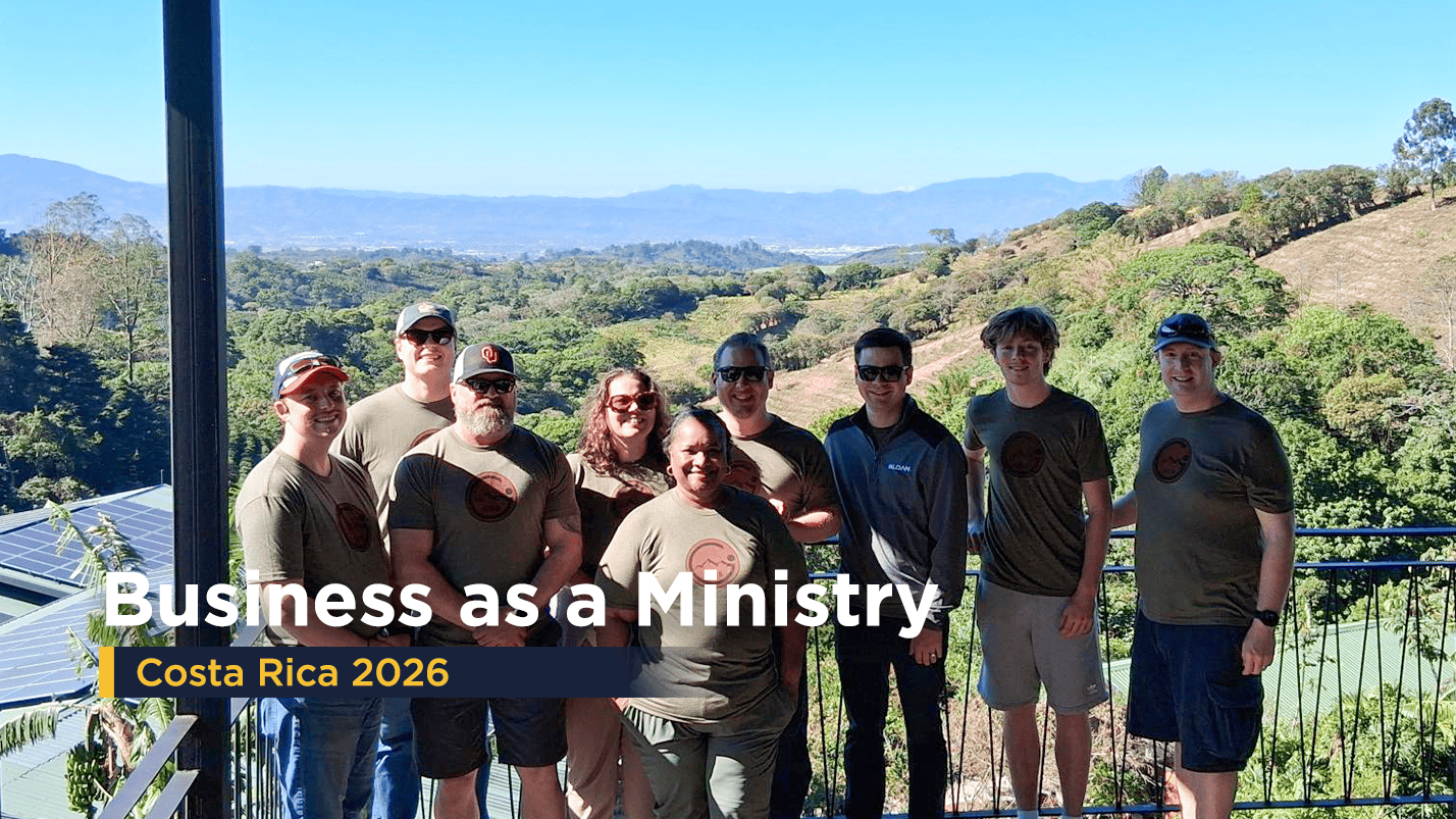 Above Group team members standing together during their annual Business as Ministry mission trip in Costa Rica, with scenic mountain views in the background.